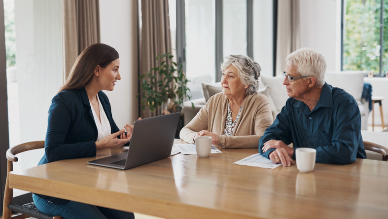 A senior couple meeting with a financial advisor to review their retirement plan.
