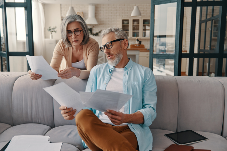 A senior couple reviewing exceptions to Roth IRA tax benefits.