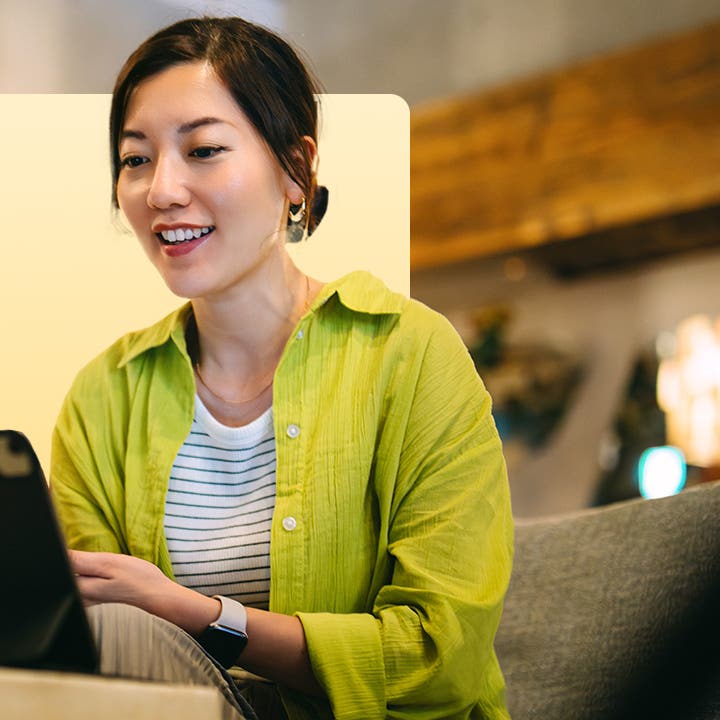 design image of a woman on her laptop smiling
